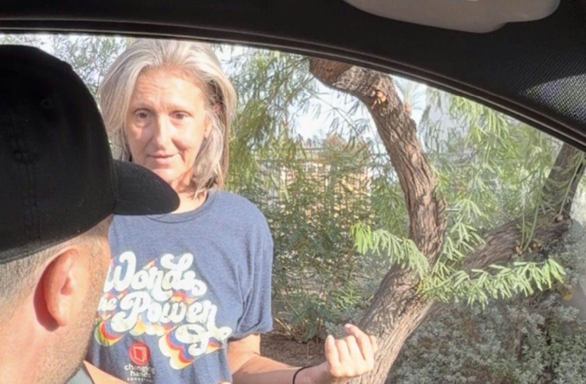 A Fresh Start volunteer talking with a woman outdoors